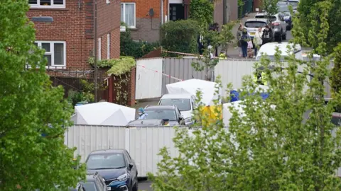 PA Media Forensic officers at the scene of the stabbings