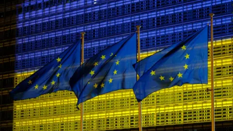 Getty Images The EU Commission headquarters in Brussels displaying the colours of the Ukrainian Flag in May 2022