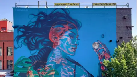 STREET ART ATLAS Mural of a underwater mermaid figure