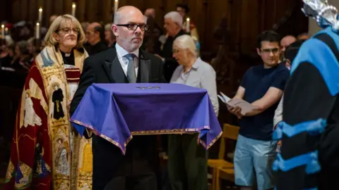 Emma Collins Abbot John's ossuary is carried to the presbytery