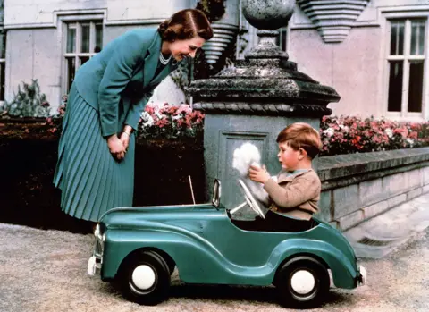 Getty Images Queen Elizabeth watches Prince Charles playing in his toy car while at Balmoral, September 1952