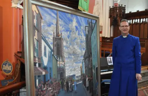 Tanya Talaga/Getty Images A painting of the Queen's cross-community visit, by artist Hector McDonnell, was unveiled a year later in 2013
