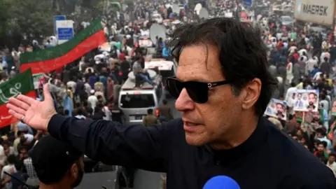 Getty Images In this photograph taken on November 1, 2022, Pakistan's former prime minister Imran Khan speaks while taking part in an anti-government march in Gujranwala. - Khan was shot in the foot at a political rally on November 3, 2022 but he is in a stable condition, an aide said.