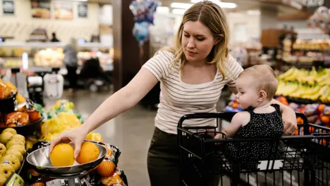 Getty Images Woman looking at items in a supermarket