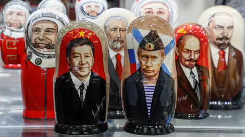 EPA Russian matryoshka dolls with portraits of the Chinese President Xi Jinping and Russian President Vladimir Putin sold on a street souvenir shop in downtown Moscow, Russia, 20 March 2023