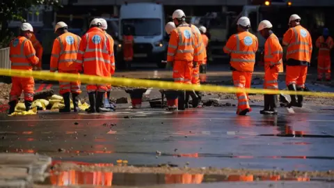 PA Media Thames Water officials work in Tollington Road near to the junction with Hornsey Road, Holloway, north London, after a 36-inch water main burst, causing flooding up to four feet deep