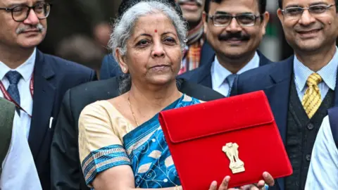 Getty Images Nirmala Sitharaman, India's finance minister, center, leaves to present the budget at the parliament on Thursday