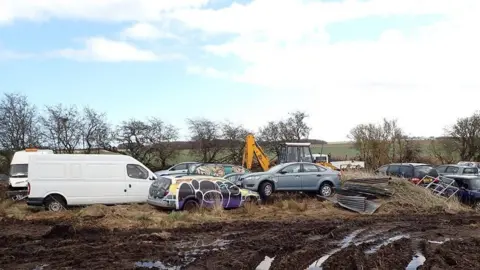 Environment Agency Vans and cars in a field
