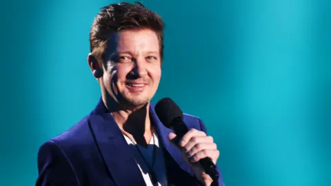 Getty Images Jeremy Renner speaks onstage during the 2024 People's Choice Awards held at Barker Hangar on February 18, 2024 in Santa Monica, California.