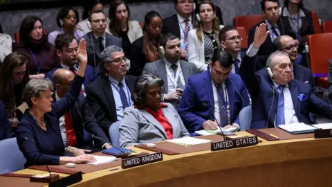 Reuters UK envoy to the UN Barbara Woodward and Algeria's envoy Amar Bendjama vote in favour of a UN Security Council resolution demanding an immediate ceasefire in Gaza, at the UN's headquarters in New York (25 March 2024)