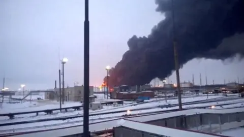 Reuters Black smoke billows from a building on fire