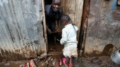 Reuters A resident tries to clean his house marooned in flood waters after the Nairobi river burst its banks within the Mathare valley settlement in Nairobi, Kenya April 24, 2024