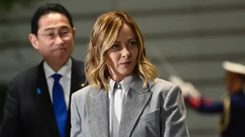 Getty Images Italy's premier, Giorgia Meloni, with Japanese premier, Shinzo Abe, at a ceremony to hand over the G7 presidency in February 2024