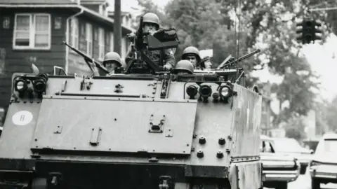John Fletcher An image of a US Army tank patrolling through the streets of Detroit in 1967.