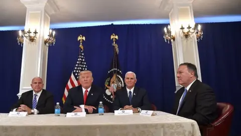 Getty Images Trump listens to a question from a reporter