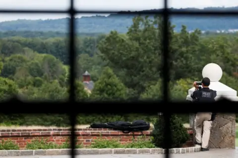 Reuters Secret Service scan the horizon outside a room where Trump holds a meeting