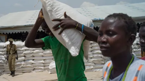 Getty Images Food is distributed by WFP, 'World Food Programme' at the Bidi Bidi refugee camp on February 22, 2017 in Arua, Uganda. T
