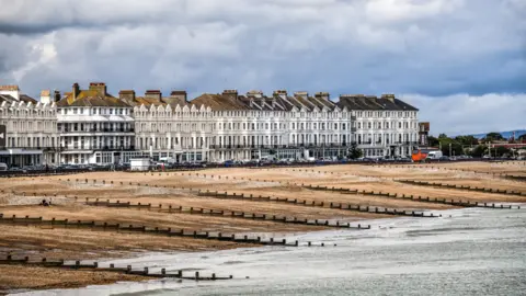 Getty Images The beach at Eastbourne, showing groynes, the pebbles and seafront houses.