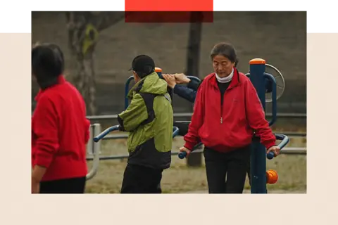BBC/Xiqing Wang A group of people on gym equipment exercise in the park