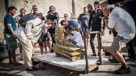 Derk Remmers/Soprintendenze del Mare Sebastiano Tusa admires an ancient rostrum recovered from the sea near Trapani (Credit: Derk Remmers/Soprintendenze del Mare)