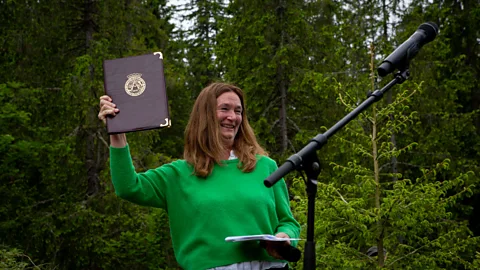 Future Library/Kristin von Hirsch Anne Beate Hovind with the contract that commits Oslo city authorities to protecting the library for 100 years (Credit: Future Library/Kristin von Hirsch)