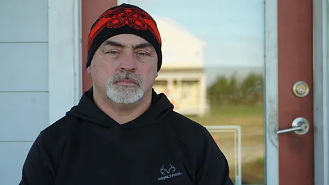 Lucy Sherriff Chris Brunet sits outside his new house in Gray, Louisiana, after coastal erosion forced him to leave his old home. 'We are climate pioneers,' he insists (Credit: Lucy Sherriff)