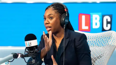 PA Media Conservative leader Kemi Badenoch being interviewed on LBC radio