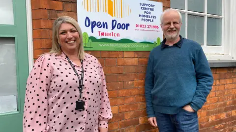 BBC Emma Busby and Andrew Davis outside Open Door