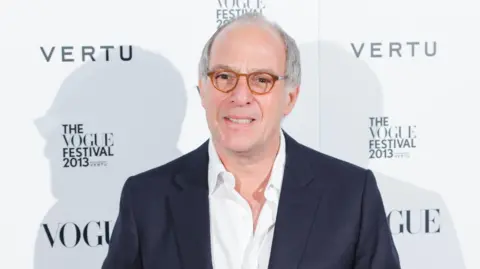 Press Association Loyd Grossman wearing a suit and glasses