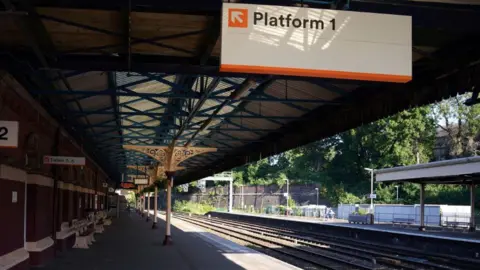 PA Wellington Train Station which is an old fashioned train station. It has a sign that says Platform 1.