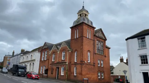 The exterior of the Open Door building, with its red brick exterior