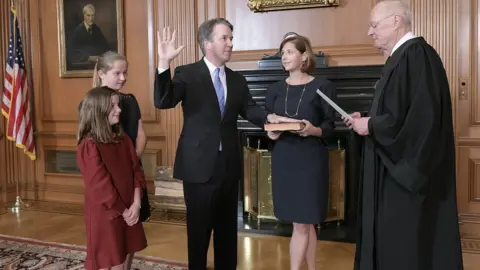 US Supreme Court Brett Kavanaugh, watched by his family, is administered the judicial oath by Justice Anthony Kennedy