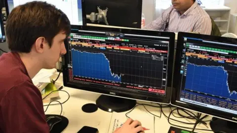 AFP Trader looking at screens