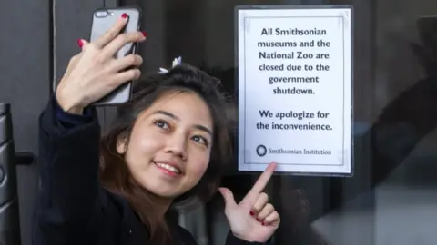 EPA A Thai tourist snaps the consequences of the partial shutdown