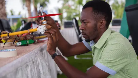 Sala Lewis/World Bank Man making a drone