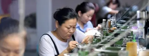 Getty Images Women work in a factory in China