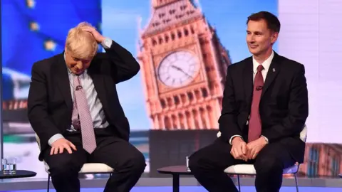 Boris Johnson and Jeremy Hunt sitting on stools during the BBC TV debate