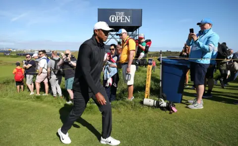 PA Media Tiger Woods walks past spectators at Royal Portrush during his first practice round for the Open