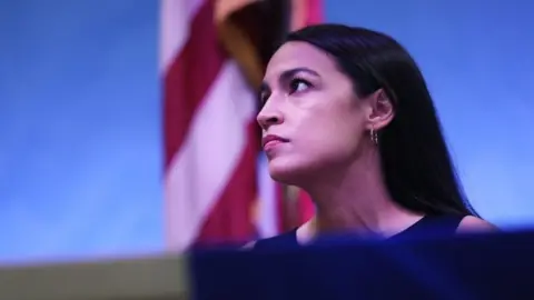 Getty Images Ocasio-Cortez holds a meeting at the Town Hall in Queens, New York