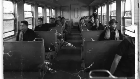 DC-Cam Pol Pot, front left, sits on a train in 1975, with Nuon Chea directly behind