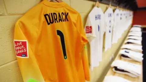 Alex Grimm/Fifa/Getty The shirt of Lizzie Durack of England hangs in the dressing room prior to the FIFA U-20 Women's World Cup Canada 2014 group C match between England and Korea Republic