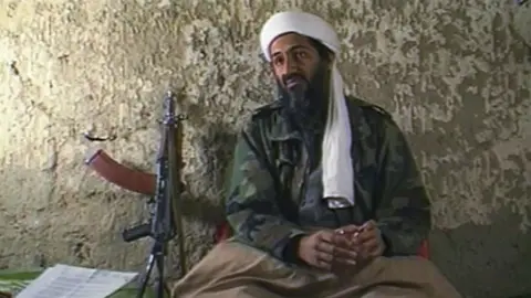 Getty Images Osama Bin Laden, the Saudi millionaire and fugitive leader of the terrorist group al Qaeda, explains why he has declared a "jihad" or holy war against the United States on August 20, 1998 from a cave hideout somewhere in Afghanistan.