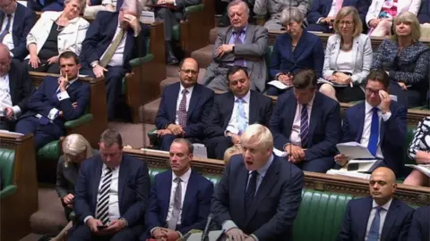 PA Media Theresa May watches Boris Johnson