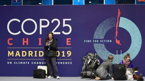AFP People wait outside the COP25 venue in Madrid