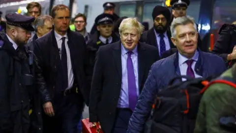 Reuters Boris Johnson walks through London's Euston station