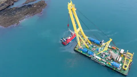 UP AND ABOVE AERIAL MEDIA Salvage Experts retrieve boat