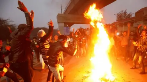Reuters Protesters burn an effigy of Indian PM Narendra Modi in Delhi. Photo: 16 December 2019