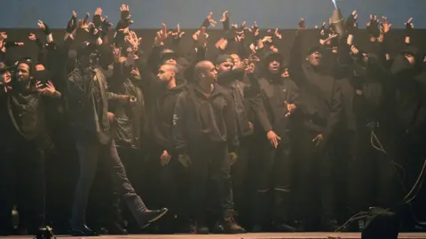 Getty Images Kanye West on stage at the Brits with grime artists behind him