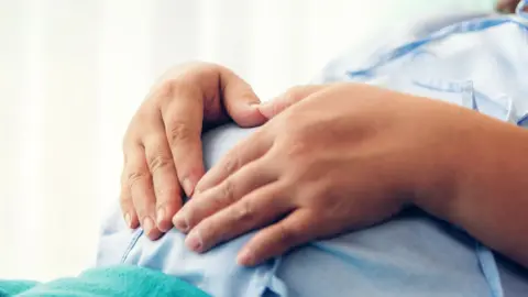 Getty Creative Pregnant woman lying on the bed waiting to give birth in a hospital