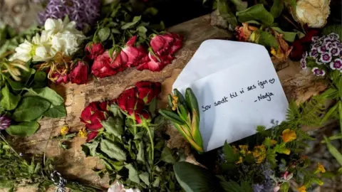 Reuters Flowers were left at the scene of the killing along with a letter that said: "Sleep well until we see each other again, Nadja"